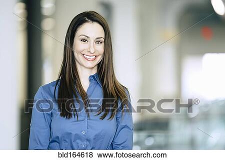 Stock Photo - Caucasian businesswoman smiling in office. Fotosearch