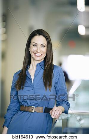 Caucasian businesswoman smiling in office View Large Photo Image Stock Photo - Caucasian businesswoman smiling in office. Fotosearch