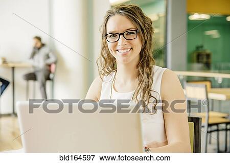 Caucasian businesswoman using laptop in cafe View Large Photo Image Stock Photo - Caucasian businesswoman using laptop in cafe. Fotosearch