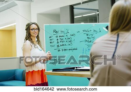 Caucasian businesswomen talking in office meeting View Large Photo Image Stock Image - Caucasian businesswomen talking in office meeting. Fotosearch