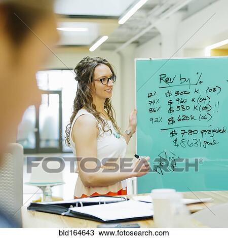 Stock Image - Caucasian businesswomen talking in office meeting. Fotosearch