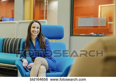 Stock Photograph - Caucasian businesswomen talking in office lobby. Fotosearch