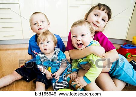 Caucasian children hugging on floor View Large Photo Image Stock Photograph - Caucasian children hugging on floor. Fotosearch