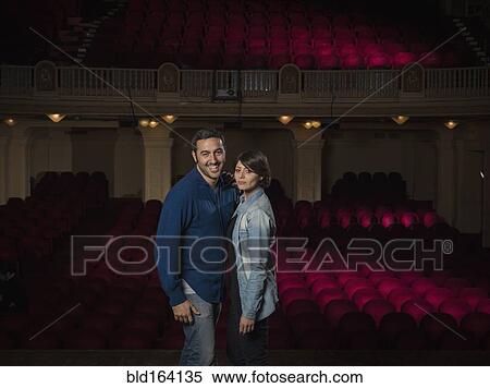 Caucasian couple standing in movie theater View Large Photo Image Stock Photography - Caucasian couple standing in movie theater. Fotosearch
