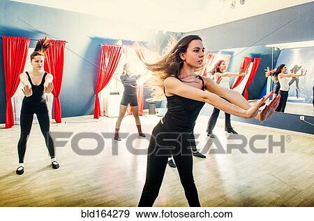 Stock Photo - Caucasian dancers rehearsing in studio. Fotosearch