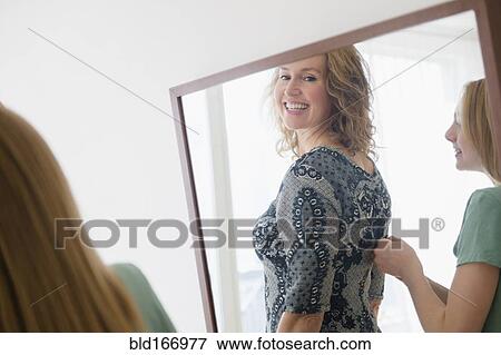 Caucasian daughter zipping dress for mother View Large Photo Image Stock Photo - Caucasian daughter zipping dress for mother. Fotosearch