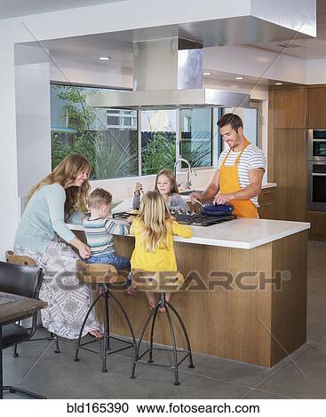 Caucasian family cooking in kitchen View Large Photo Image Stock Image - Caucasian family cooking in kitchen. Fotosearch