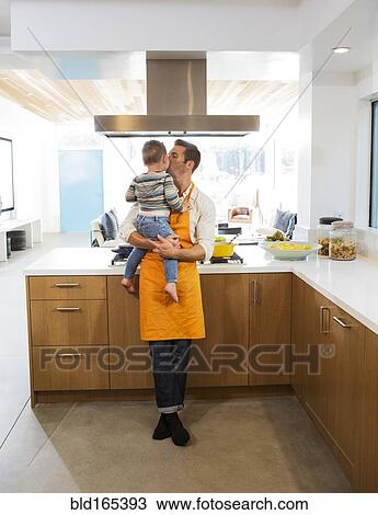 Caucasian father kissing daughter in kitchen View Large Photo Image Stock Image - Caucasian father kissing daughter in kitchen. Fotosearch