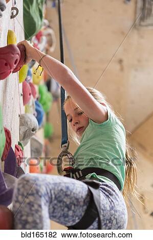 Caucasian girl climbing rock wall indoors View Large Photo Image Stock Image - Caucasian girl climbing rock wall indoors. Fotosearch