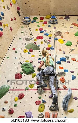 Caucasian girl climbing rock wall indoors View Large Photo Image Stock Image - Caucasian girl climbing rock wall indoors. Fotosearch