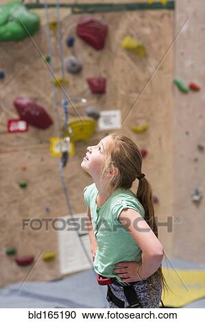 Caucasian girl examining rock wall indoors View Large Photo Image Stock Image - Caucasian girl examining rock wall indoors. Fotosearch