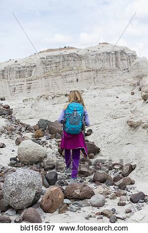 Stock Photo - Caucasian girl exploring desert rock formations. Fotosearch