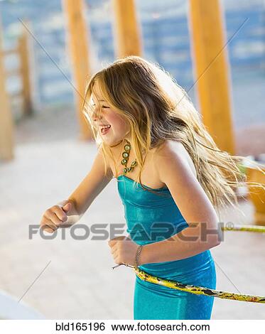 Caucasian girl playing with plastic hoop View Large Photo Image Stock Photograph - Caucasian girl playing with plastic hoop. Fotosearch