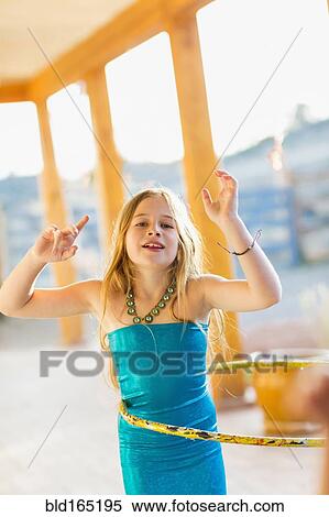 Caucasian girl playing with plastic hoop View Large Photo Image Stock Photography - Caucasian girl playing with plastic hoop. Fotosearch