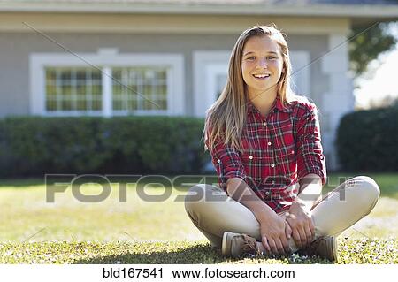 Caucasian girl sitting in backyard View Large Photo Image Stock Image - Caucasian girl sitting in backyard. Fotosearch