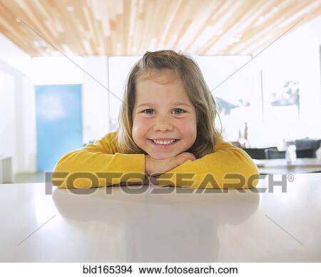 Picture - Caucasian girl smiling on counter. Fotosearch
