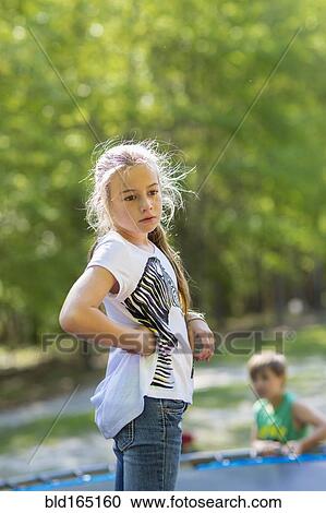 Caucasian girl standing on trampoline View Large Photo Image Stock Image - Caucasian girl standing on trampoline. Fotosearch