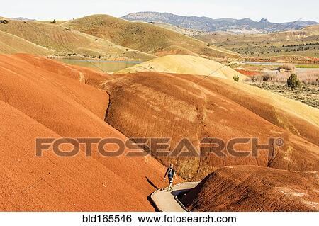 Caucasian hiker on wooden walkway in desert hills View Large Photo Image Stock Photograph - Caucasian hiker on wooden walkway in desert hills. Fotosearch