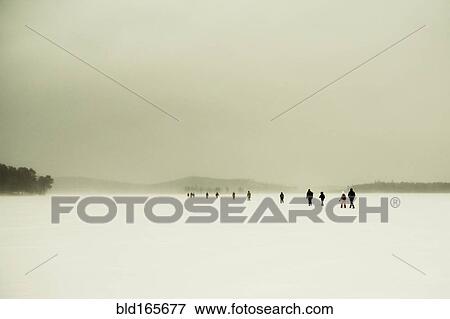 Caucasian hikers walking in snowy remote field View Large Photo Image Stock Photo - Caucasian hikers walking in snowy remote field. Fotosearch