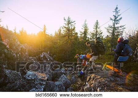 Stock Image - Caucasian hikers walking on remote mountainsides. Fotosearch