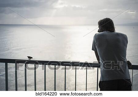 Caucasian man admiring ocean view from railing View Large Photo Image Stock Image - Caucasian man admiring ocean view from railing. Fotosearch