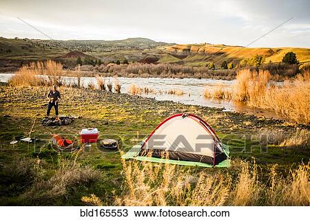 Caucasian man camping near remote river, Painted Hills, Oregon, United States View Large Photo Image Stock Image - Caucasian man camping near remote river, Painted Hills, Oregon, United States. Fotosearch