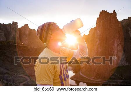 Caucasian man drinking water bottle in desert landscape, Smith Rock State Park, Oregon, United States View Large Photo Image Stock Photo - Caucasian man drinking water bottle in desert landscape, Smith Rock State Park, Oregon, United States. Fotosearch