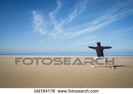 Caucasian man practicing yoga on beach View Large Photo Image Stock Photo - Caucasian man practicing yoga on beach. Fotosearch