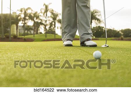 Caucasian man standing on golf course green View Large Photo Image Stock Image - Caucasian man standing on golf course green. Fotosearch