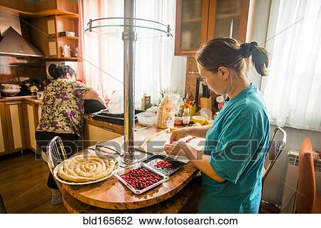 Caucasian mother and daughter baking in kitchen View Large Photo Image Stock Image - Caucasian mother and daughter baking in kitchen. Fotosearch