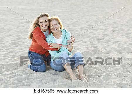 Caucasian mother and daughter hugging on beach View Large Photo Image Stock Photography - Caucasian mother and daughter hugging on beach. Fotosearch
