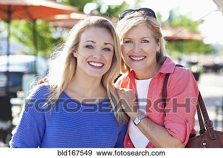 Stock Photo - Caucasian mother and daughter smiling outdoors. Fotosearch