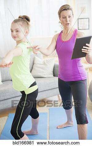 Caucasian mother and daughter practicing yoga with digital tablet View Large Photo Image Stock Image - Caucasian mother and daughter practicing yoga with digital tablet. Fotosearch