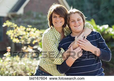 Caucasian mother and son hugging outdoors View Large Photo Image Picture - Caucasian mother and son hugging outdoors. Fotosearch