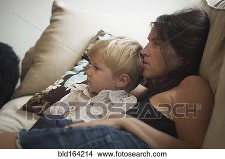 Picture - Caucasian mother and son watching television. Fotosearch