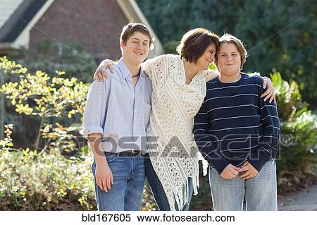 Caucasian mother and sons hugging outdoors View Large Photo Image Stock Photography - Caucasian mother and sons hugging outdoors. Fotosearch