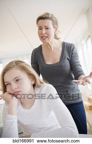 Stock Image - Caucasian mother arguing with daughter. Fotosearch