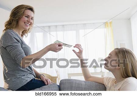 Caucasian mother giving daughter money View Large Photo Image Stock Photography - Caucasian mother giving daughter money. Fotosearch