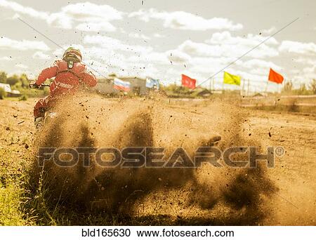 Caucasian motocross biker spraying dirt on race course View Large Photo Image Stock Image - Caucasian motocross biker spraying dirt on race course. Fotosearch