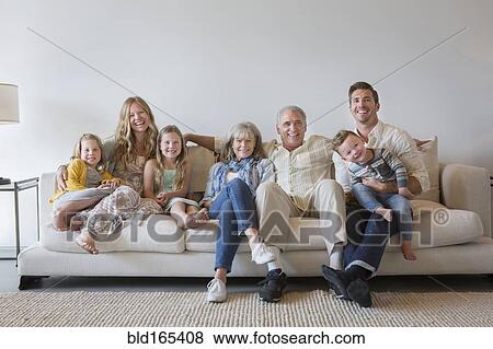 Caucasian multi-generation family sitting on sofa in living room View Large Photo Image Stock Photo - Caucasian multi-generation family sitting on sofa in living room. Fotosearch