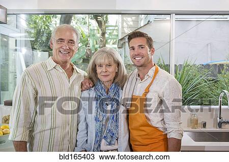Caucasian parents and son smiling in kitchen View Large Photo Image Stock Image - Caucasian parents and son smiling in kitchen. Fotosearch