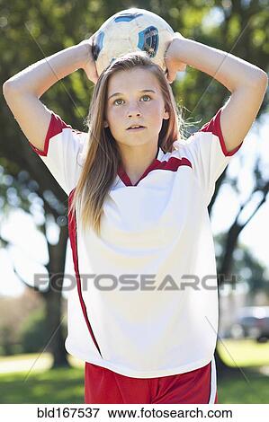 Stock Photo - Caucasian soccer player throwing ball. Fotosearch