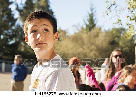 Stock Photography - Caucasian student looking up on field trip. Fotosearch