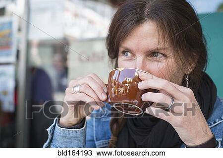 Caucasian woman drinking cup of coffee outdoors View Large Photo Image Stock Image - Caucasian woman drinking cup of coffee outdoors. Fotosearch