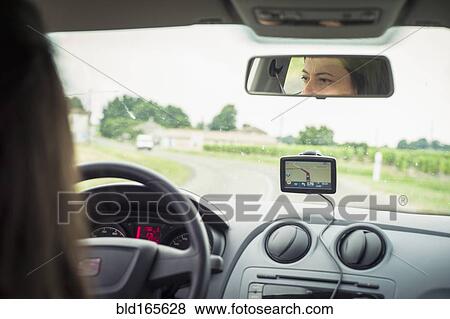 Stock Photo - Caucasian woman driving car with GPS navigation. Fotosearch