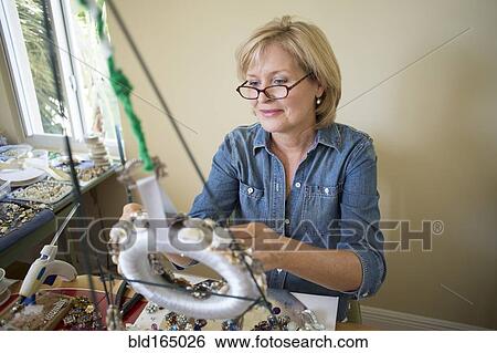 Stock Photograph - Caucasian woman making crafts. Fotosearch