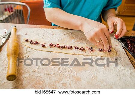 Caucasian woman placing berries in dough View Large Photo Image Stock Photo - Caucasian woman placing berries in dough. Fotosearch