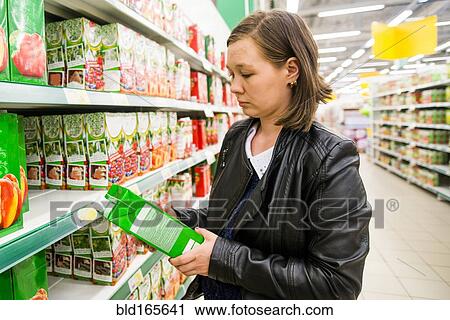 Caucasian woman shopping in grocery store View Large Photo Image Stock Image - Caucasian woman shopping in grocery store. Fotosearch
