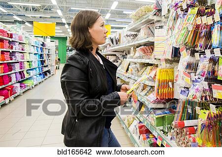 Caucasian woman shopping in grocery store View Large Photo Image Stock Image - Caucasian woman shopping in grocery store. Fotosearch