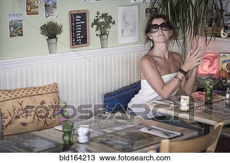Caucasian woman sitting in cafe View Large Photo Image Stock Image - Caucasian woman sitting in cafe. Fotosearch